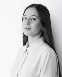 Professional headshot of Anahit Vardanyan, a young woman with long dark hair, wearing a collared shirt, looking calmly at the viewer.