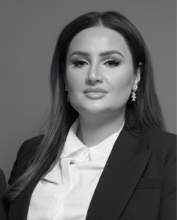 Lusine Avetisyan, a professional woman, looking directly at the viewer. She wears a black suit and white shirt.